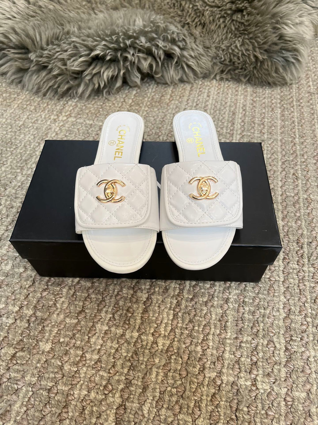 Luxury diamond-quilted flat slides with metal embellishments