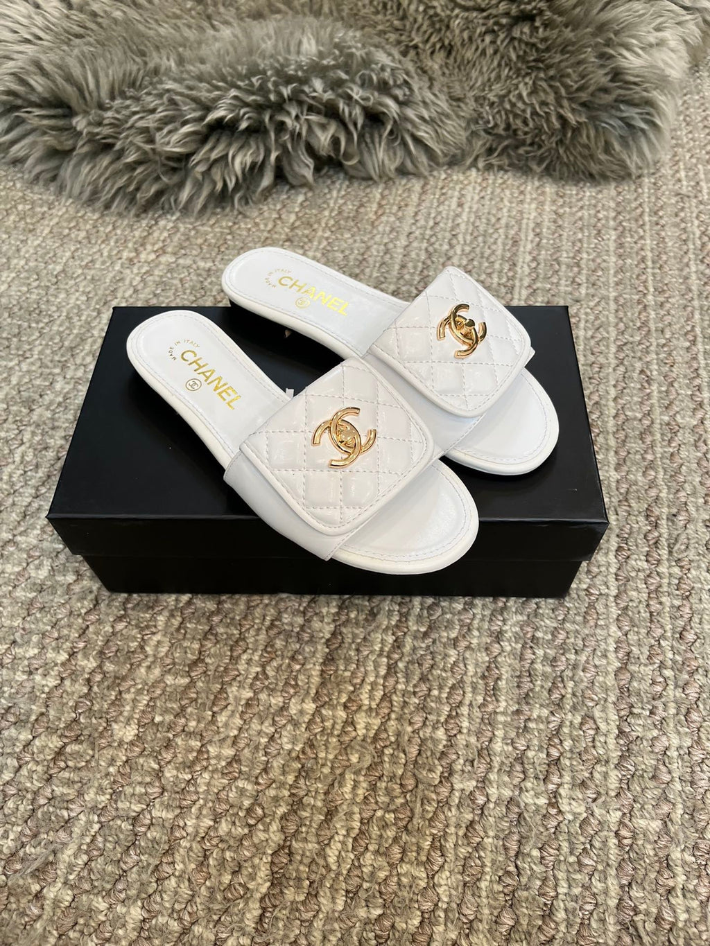 Luxury diamond-quilted flat slides with metal embellishments